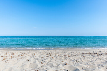 Sandy Beach and mediterranean sea during summer with large copy space, Ghisonaccia, Corsica, France. Horizon over water