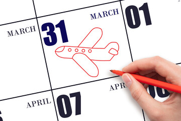 31st day of March. A hand drawing outline of airplane on calendar date 31 March. The date of flight on plane. Travel, business trips. Spring month. Day of the year