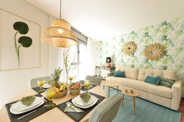 Living room of a vacation rental apartment with floral decoration and a round dining table full of fresh fruits and glasses with orange juice