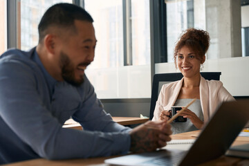 Close up photo of men and women talking in office