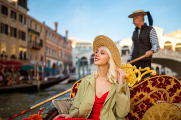 Happy smiling traveler woman on Gondola ride along the Grand Canal in Venice, Italy. Travel, vacation, lifestyle conception. Copy, empty space for text