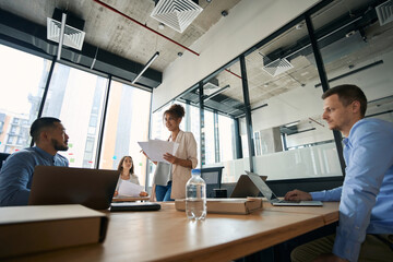 Photo of meeting of young colleagues to discuss work issues.