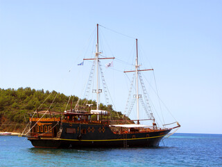 Beautiful vintage retro sailing ship sails on the sea against the blue sky	