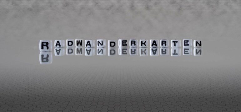 radwanderkarten Wort oder Konzept dargestellt durch schwarze und weiße Buchstabenwürfel auf einem grauen Horizonthintergrund