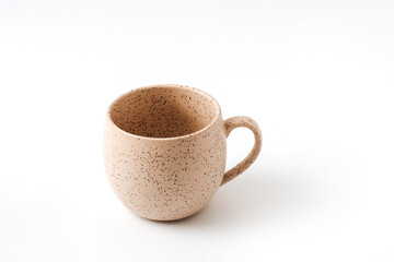 Empty beige coffee ceramic cup on isolated white background, cut out. View from above