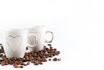On a light background with coffee beans, two cups of espresso.
