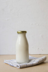 Ayran in a glass bottle on a light background