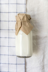 Ayran in a glass bottle on a light fabric background