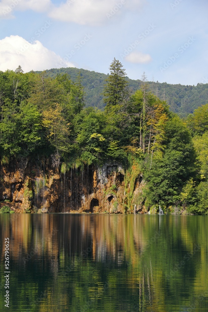 Poster beautiful view of the calm lake with reflection of trees in the water