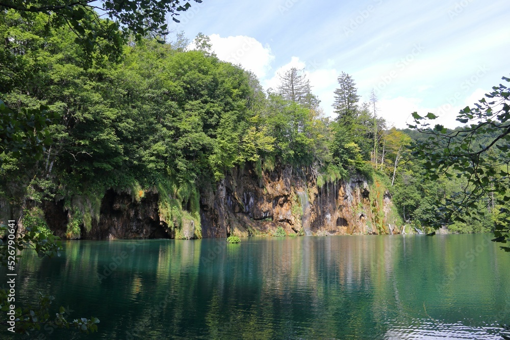 Poster beautiful view of the calm lake with reflection of trees in the water