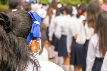 Unrecognizable Latin American student girls wearing uniforms seen from behind in Managua, Nicaragua