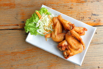 fried chicken on vegetable background in white plate