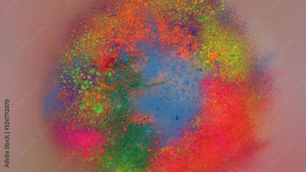 Poster sprinkle several colors of dust on the white paper that is spinning around until the dust is circula