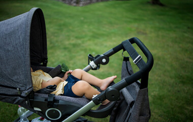 Fototapeta na wymiar Sweet little boy sleeping in a stroller