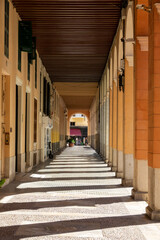 Fototapeta na wymiar Perspective view of a corridor between columns in a street in Palma de Mallorca (Spain)
