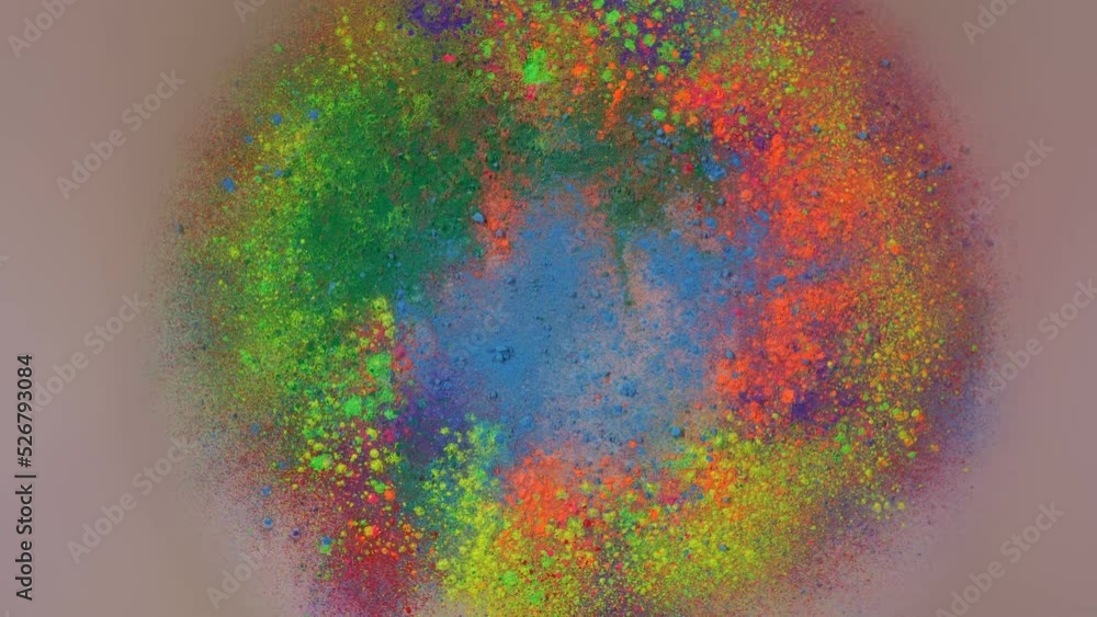 Poster sprinkle several colors of dust on the white paper that is spinning around until the dust is circula