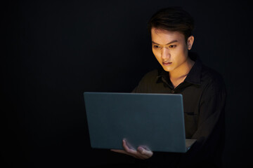 Man Working on Laptop in Dark Room