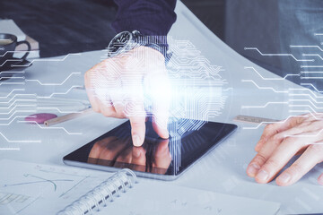 Double exposure of man's hand holding and using a digital device and brain hologram drawing. Data concept.