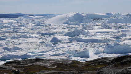 Fototapeta na wymiar Thousands of icebergs at shore at Ilulissat, Greenland