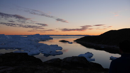 Naklejka premium View from cliff overlooking bay of icebergs in Greenland