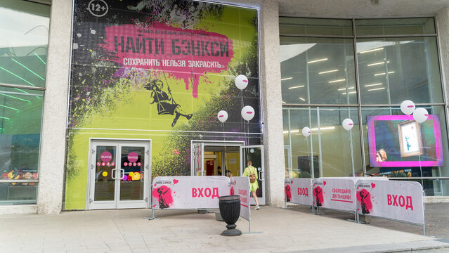 MOSCOW, Russia - AUGUST 26, 2022: exhibition of Banksy's works. There are paintings hanging on the wall. An exact copy.