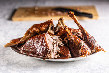 Portioned roast goose on a white plate - Close up © weyo