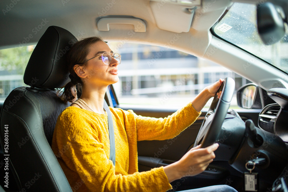 Wall mural young woman driving a car