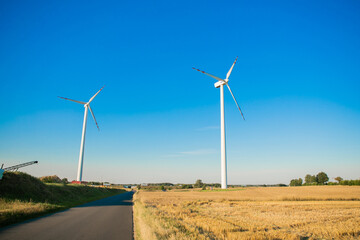 Windmills for electricity generation. Green energy concept. Background with copy space for text. Huge blades close up.