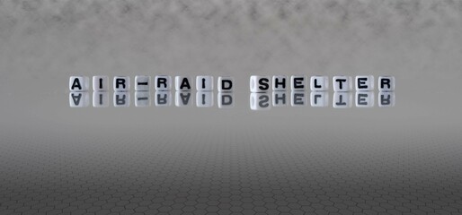 air raid shelter word or concept represented by black and white letter cubes on a grey horizon...
