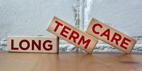 Word LONG TERM CARE on wooden blocks and beautiful background