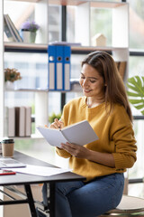 Business asian woman working on laptop computer managing her business in workplace, doing calculator planning document analyzing the financial report, business plan investment, finance analysis. 