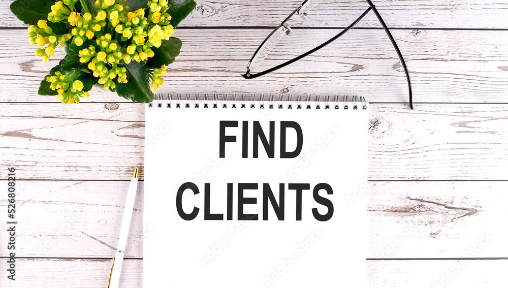 Poster find clients text concept write on notebook on wooden background