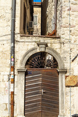 Metal sculpture of stretching cat over gate of house in Kotor, Montenegro. It is located in secluded part of Bay of Kotor. Vertical image