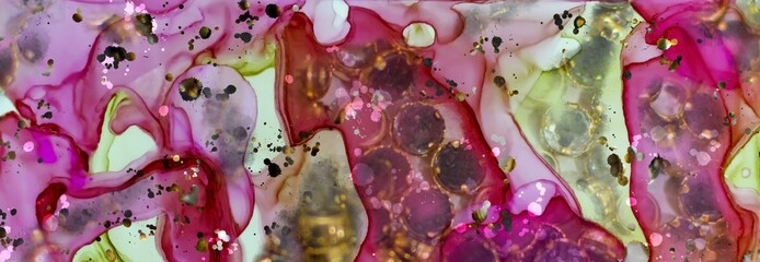 Gem studded gold rings on Alcohol ink fluid abstract texture fluid art with gold glitter and liquid.
