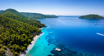 Fototapeta na wymiar Aerial view of the beautiful coast of Skopelos island with turquoise sea at pristine beaches and thick pine forest, Sporades, Greece