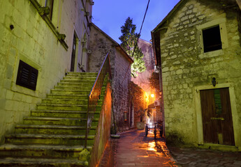 Empty street of Kotor old town at night off season. Historical buildings, cobblestone pavement, ancient churches are attraction for tourists in Montenegro on any season.