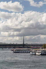 View of parked tour boats on Golden Horn part of Bosphorus and Halic bridge in Istanbul. It is a sunny summer day.