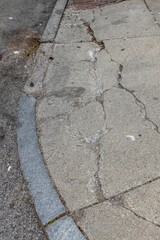Cracked concrete sidewalk needing repair