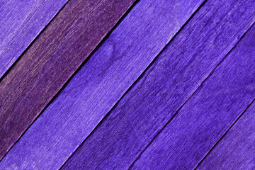 Old painted purple wood planks. Textured wooden backdrop. Purple detailed boards are arranged...