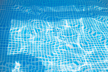 Background texture. Blue Water in the pool. Distorted cell curve