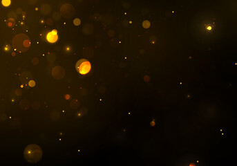 Gold, yellow bokeh effect on black background. Sparkling magical particles.