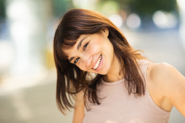 Elegant young woman smiling outside