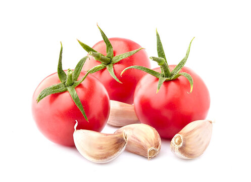 Fresh tomatoes with  garlic isolated on white background.