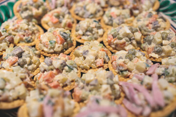 Catering banquet table, beautifully decorated with variety selection of different food snacks and appetizers on a corporate birthday party event or wedding celebration, delicatessen setting