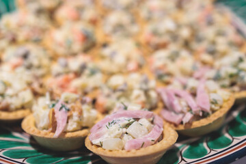 Catering banquet table, beautifully decorated with variety selection of different food snacks and appetizers on a corporate birthday party event or wedding celebration, delicatessen setting