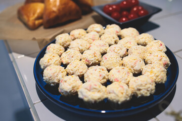 Catering banquet table, beautifully decorated with variety selection of different food snacks and appetizers on a corporate birthday party event or wedding celebration, delicatessen setting