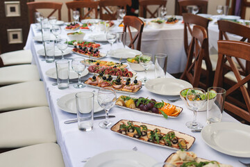 Catering table, beautifully decorated banquet with variety selection of different food snacks and...