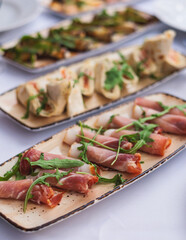 Catering table, beautifully decorated banquet with variety selection of different food snacks and appetizers on a corporate birthday party event or wedding celebration, delicatessen setting