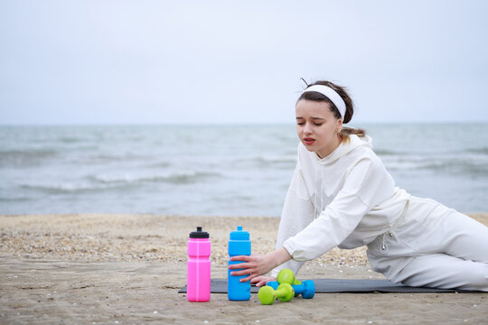 Beautiful athlete feeling thursty and try to drink water