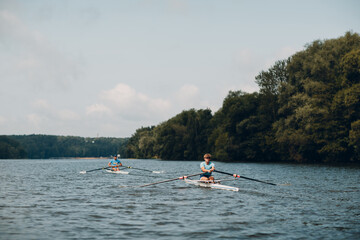 Fototapeta na wymiar Sportsman single scull man rower rowing on boat.